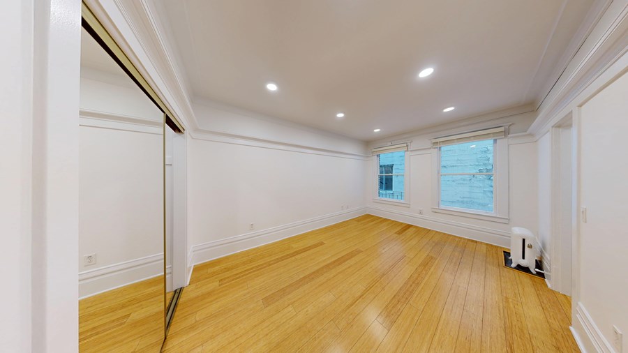 A room with wooden floors and white walls.